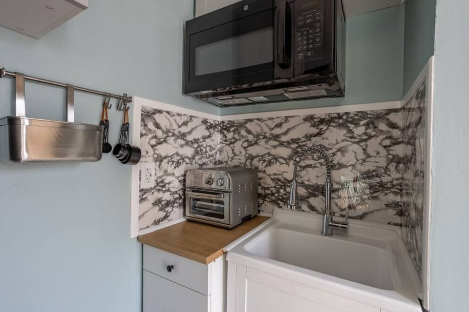 Small but efficient kitchenette w/ air fryer for easy meal prep.