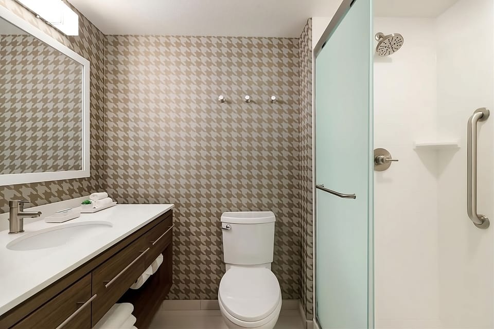 Refresh under a rainfall shower in a spotless modern bath.
