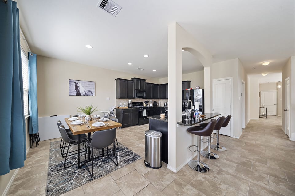 Spacious dining table that sits 6 with full tableware and silverware included.