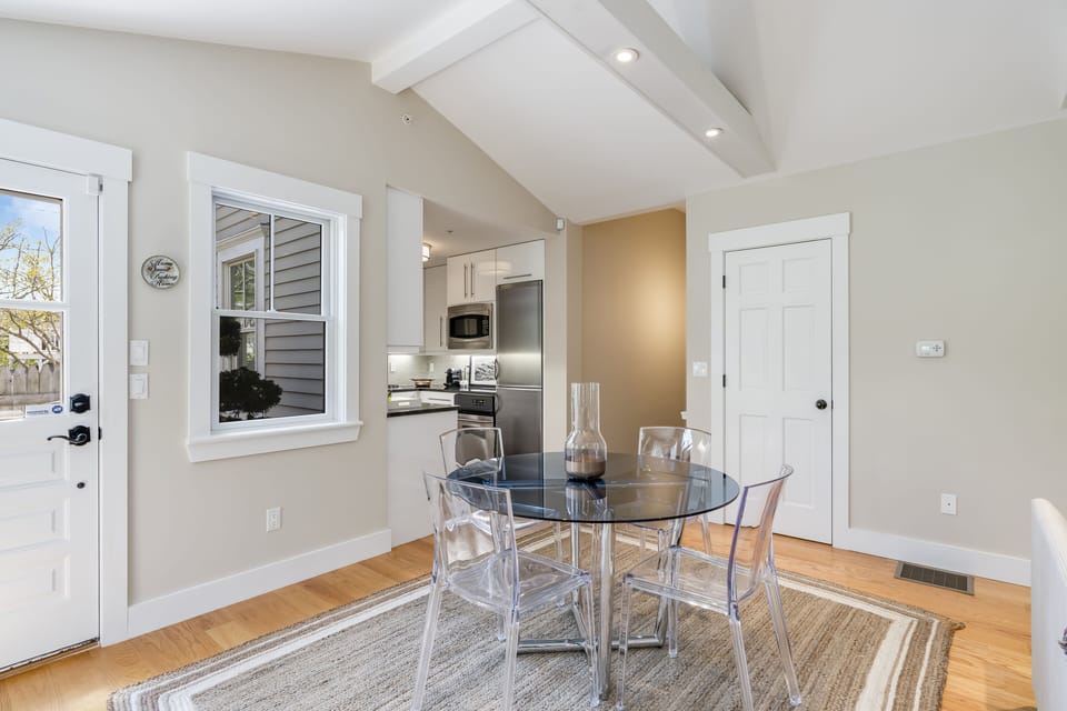 View of dining area looking into kitchen and stairs to lower level