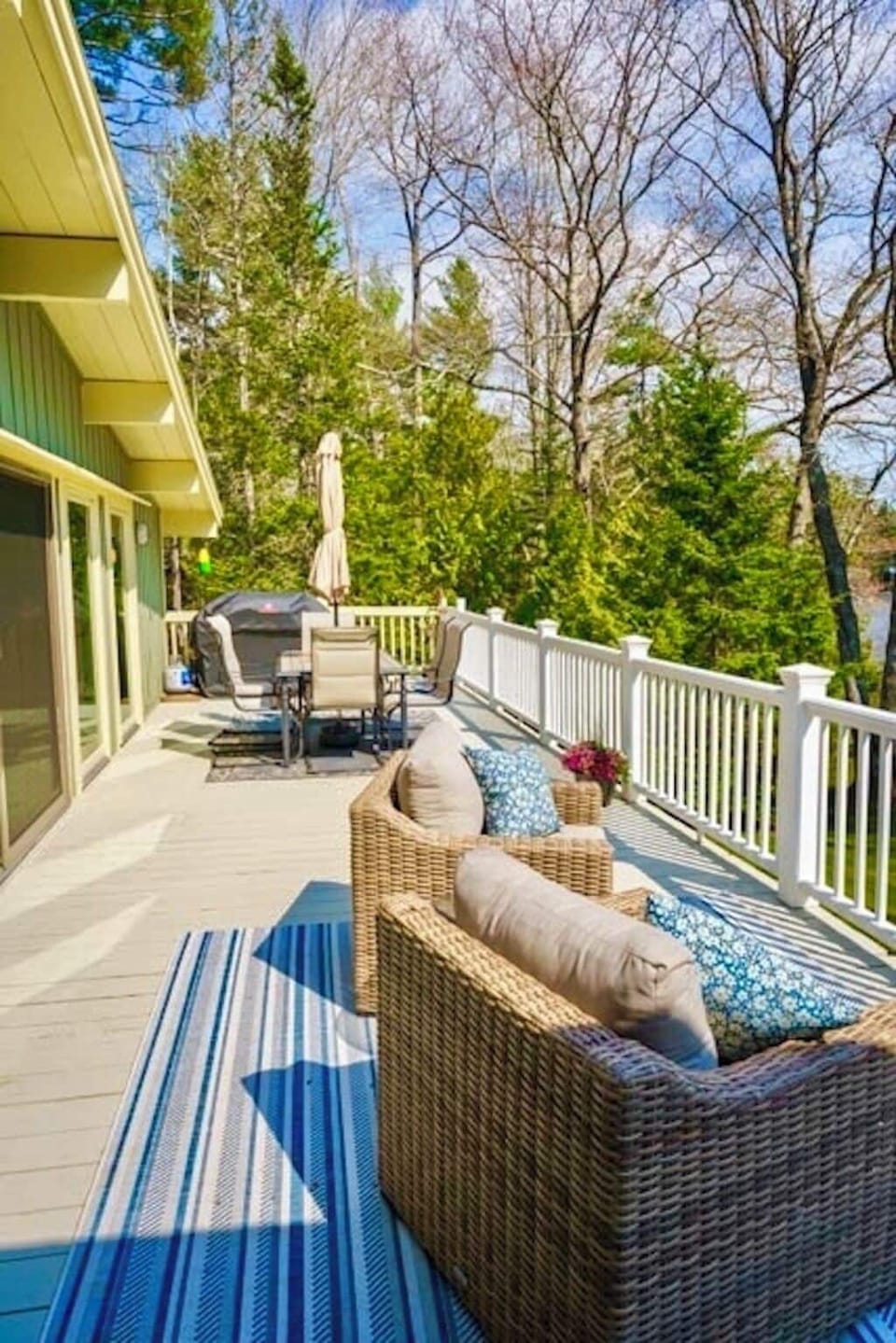 Large outdoor deck with dining and comfy furniture