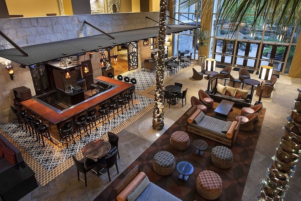 Unwind beneath soaring atrium light with stylish lounge seating.