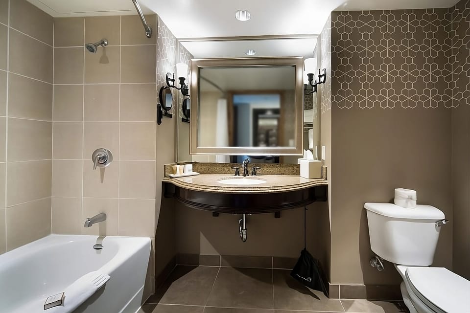 Refresh with a full bath, bright vanity, and deep tub.