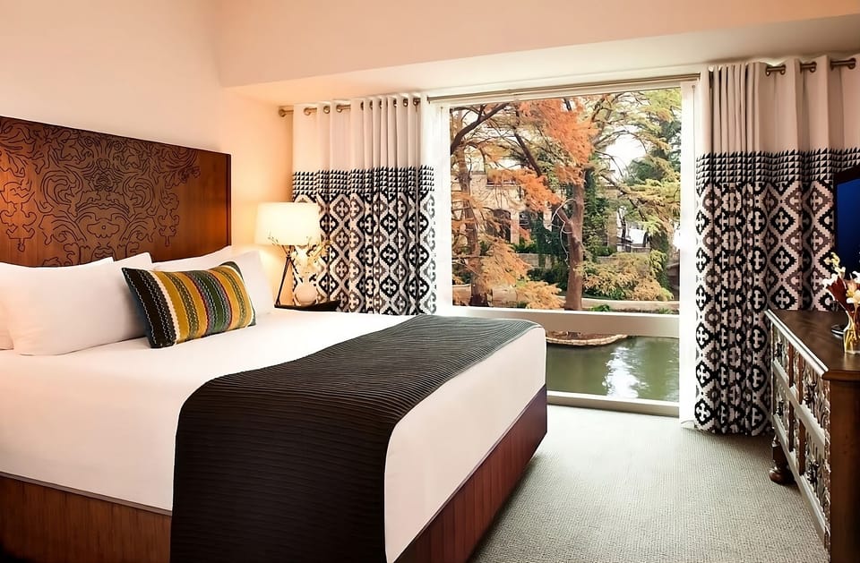 Wake up to peaceful water views framed by elegant drapes.