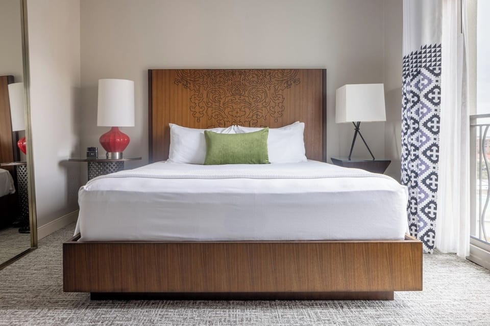 Refresh in a sunlit king room overlooking the skyline.