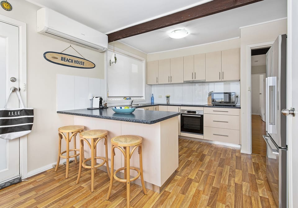 Kitchen - fully equipped. Sit on a stool & enjoy a coffee whilst gazing at beach