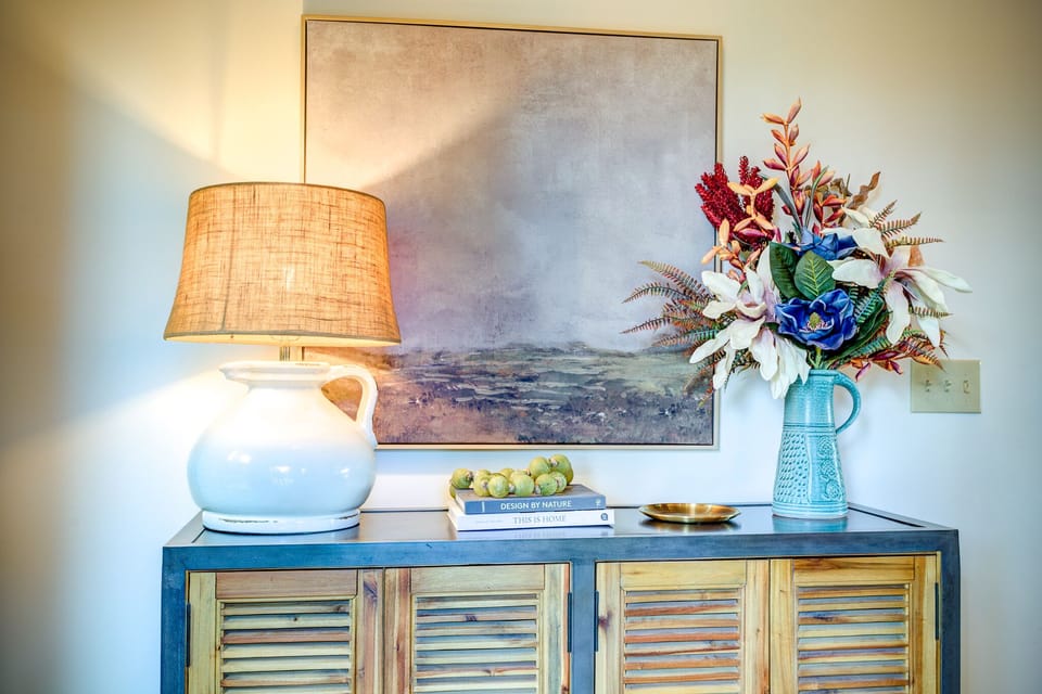 Foyer enterance includes cabinet with overflow kitchen dishware and kids items.