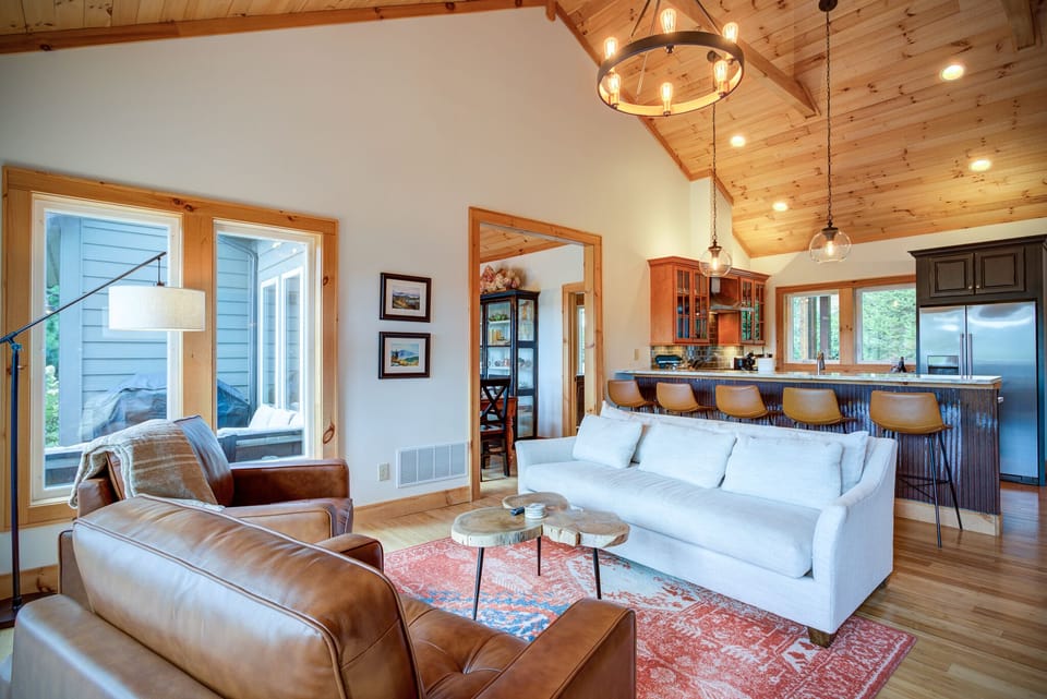 Stunning yellow pine vaulted living room and kitchen, with dining room on left.
