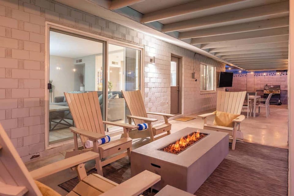 Unwind by your private fire pit after a long day, where cozy Adirondack chairs invite you to relax under the covered patio and enjoy peaceful evenings outdoors.