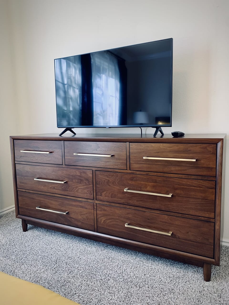Both guest bedrooms feature spacious mid-century modern dressers and 43" tvs