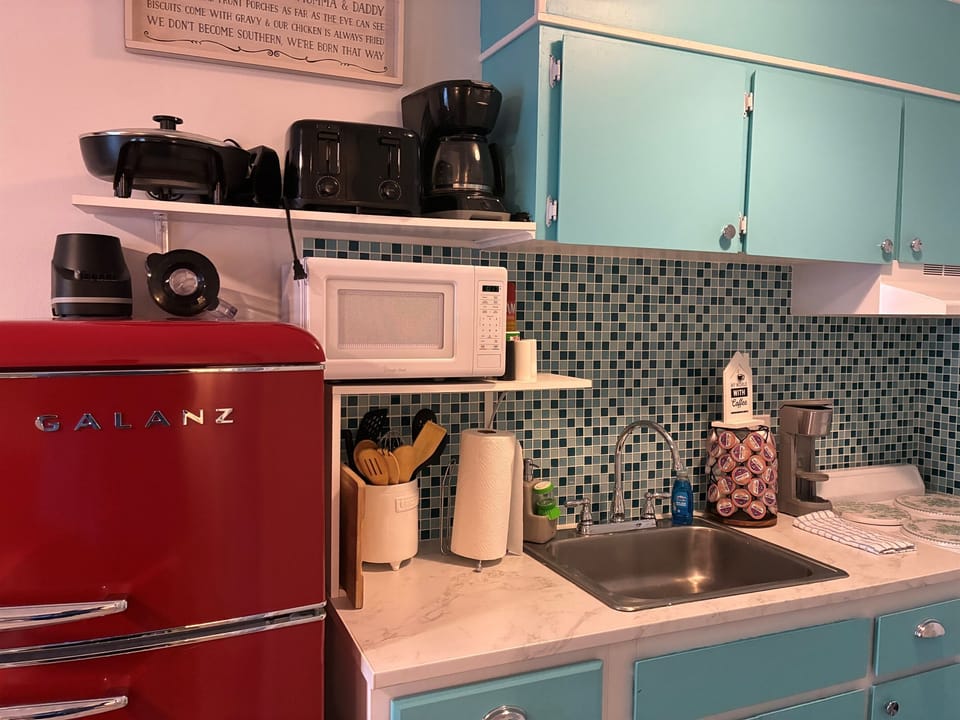 Well equipped kitchen with coffee maker, blender, toaster, electric skillet and other items 