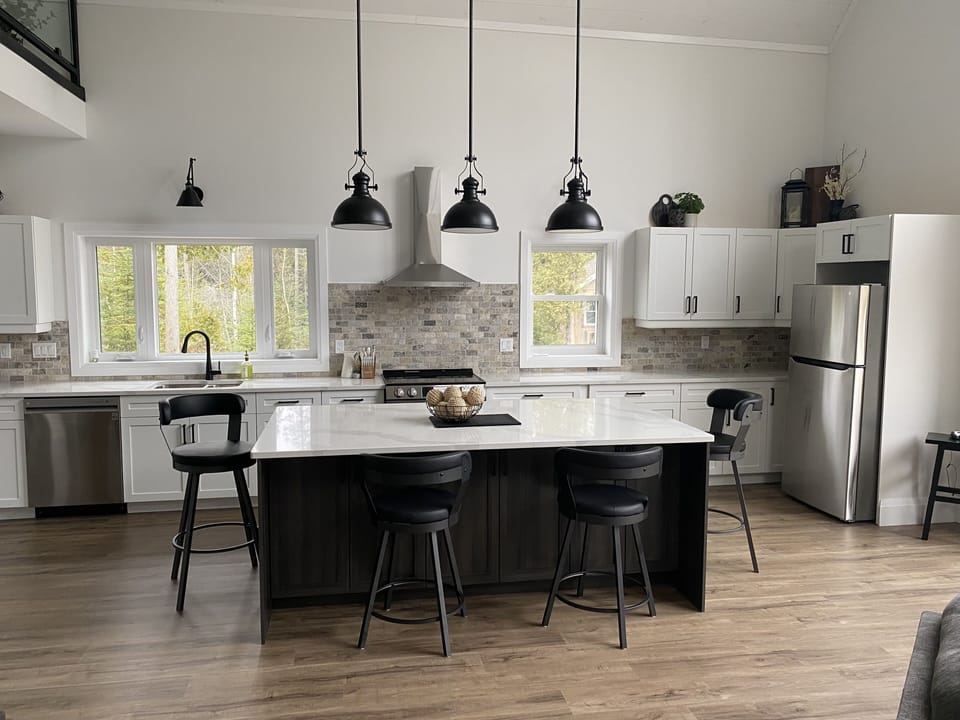 Open concept kitchen with dishwasher, drawer microwave, stove and refrigerator