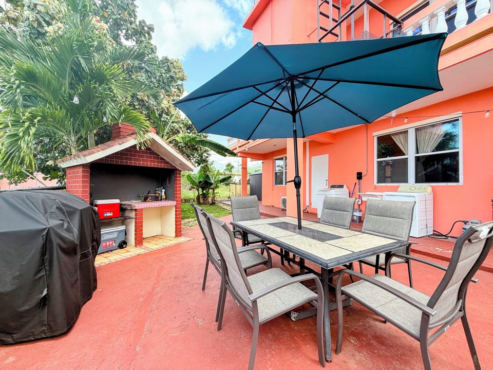 Spacious patio with shaded dining and BBQ for outdoor gatherings