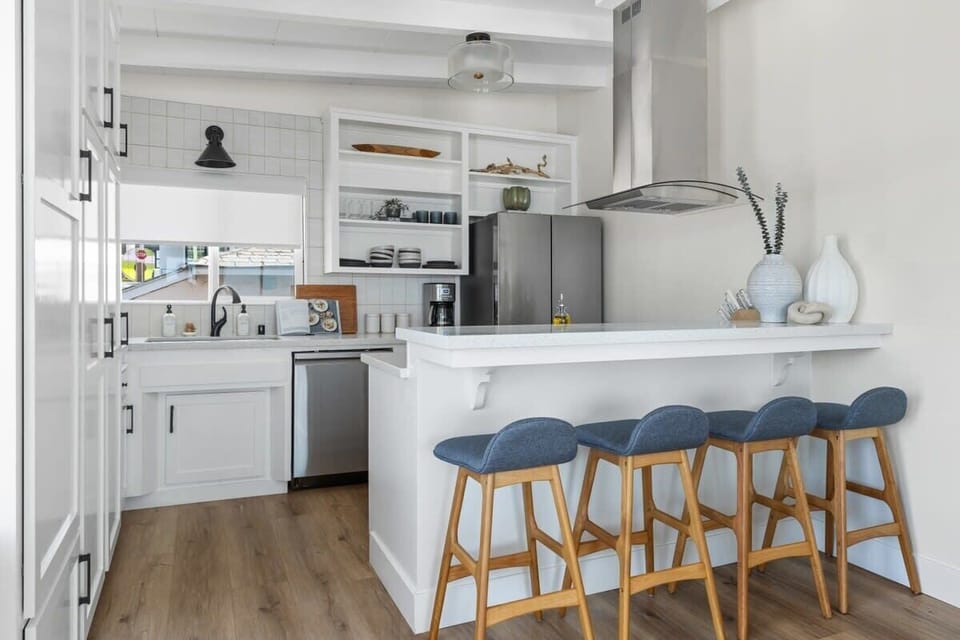 The home's sleek and modern kitchen features top-of-the-line appliances and fixtures, providing a beautiful and functional space for cooking and dining.