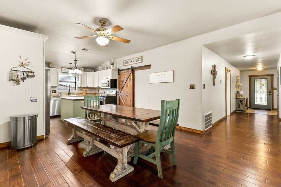 Gather around a large wooden dining table perfect for family meals, game nights, and shared moments. It’s a welcoming space for big groups.
