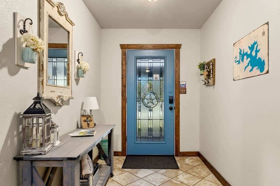 Walk into a warm farmhouse entryway with charming decor, bright light, and a cozy feel that sets the tone for your stay.