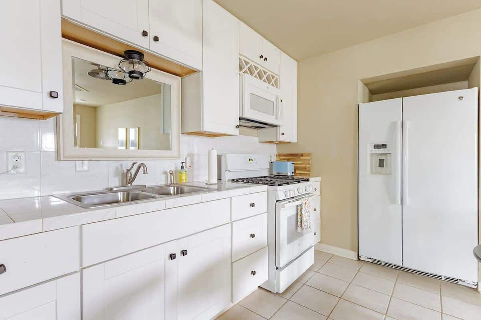 Prepare home-cooked meals with ease in the bright and spacious kitchen complete with modern appliances and farmhouse charm just a short drive from Lake Placid and New Braunfels
