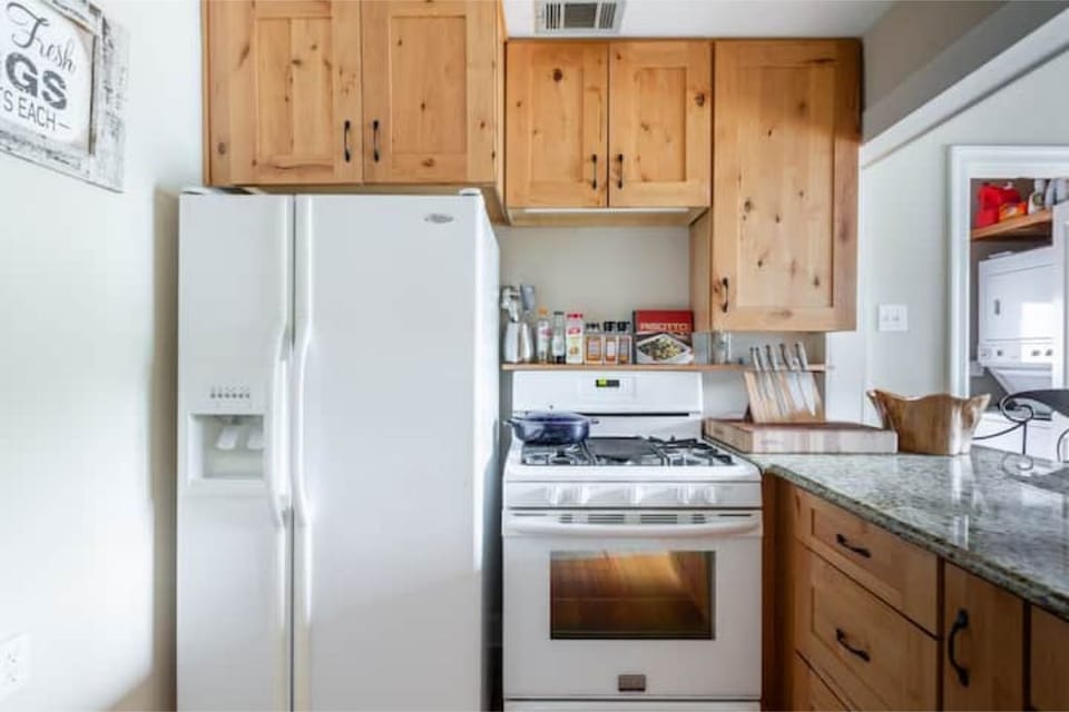 Fully equipped kitchen with view of backyard and pool
