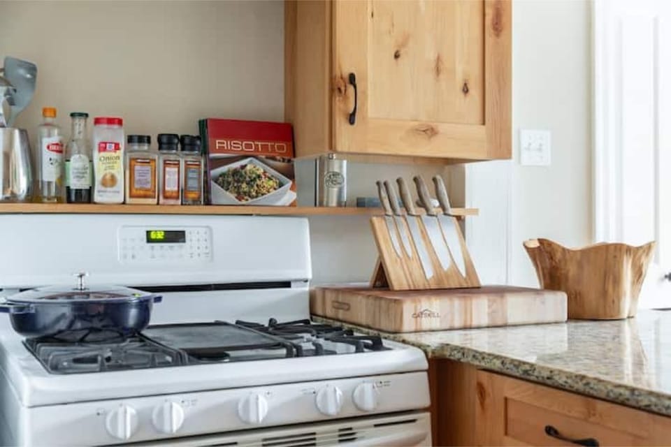 Fully equipped kitchen with view of backyard and pool
