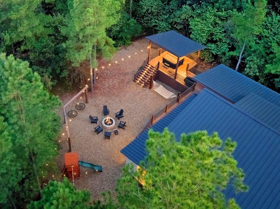 Backyard—hot tub, fire pit, playset, swings, bbq, hammock, porch with TV.  