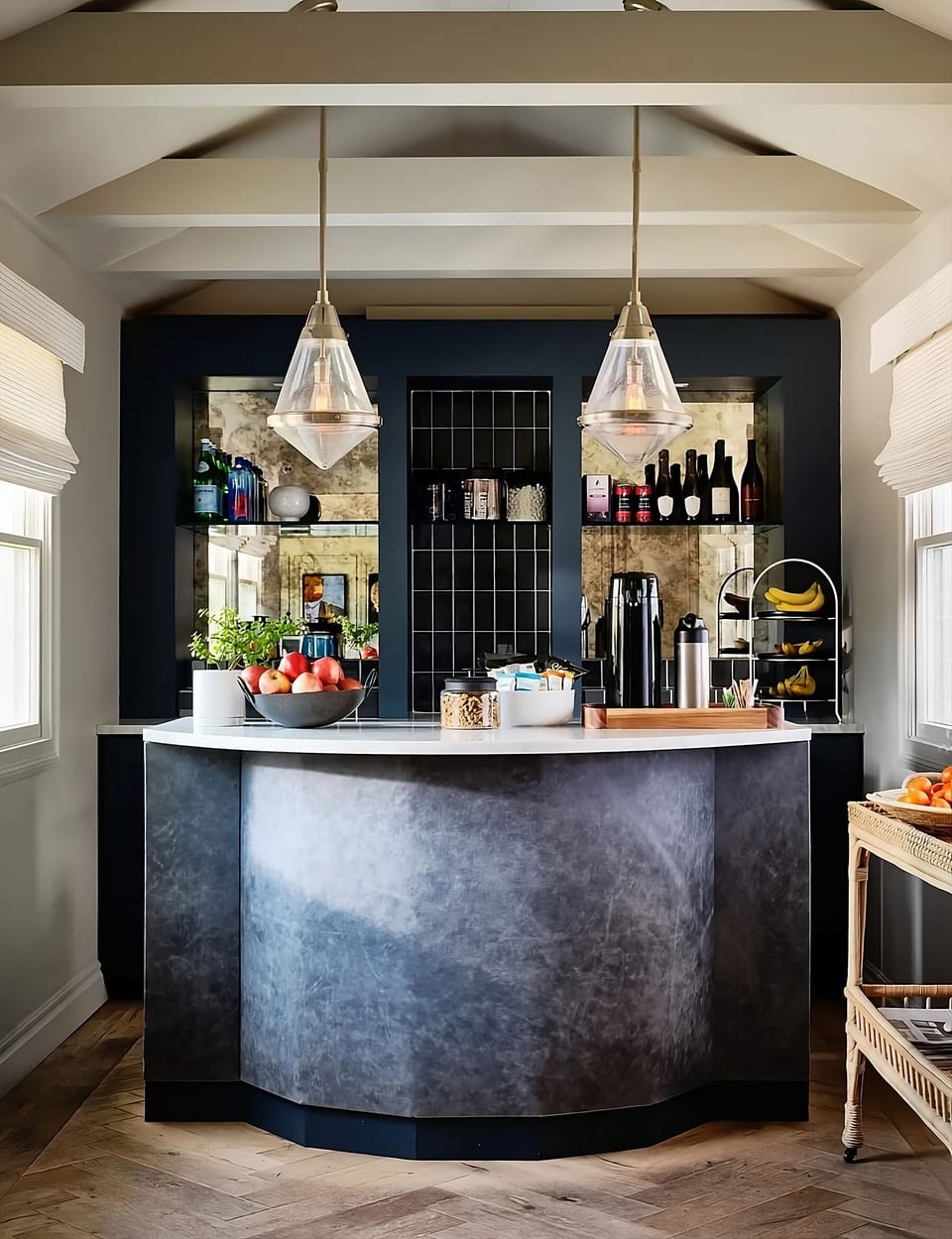 Sip cocktails at the stylish bar under warm pendant lights.