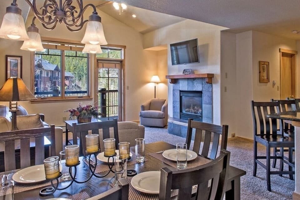 Master Living Room with a gas fireplace, flat screen TV, and a private balcony.