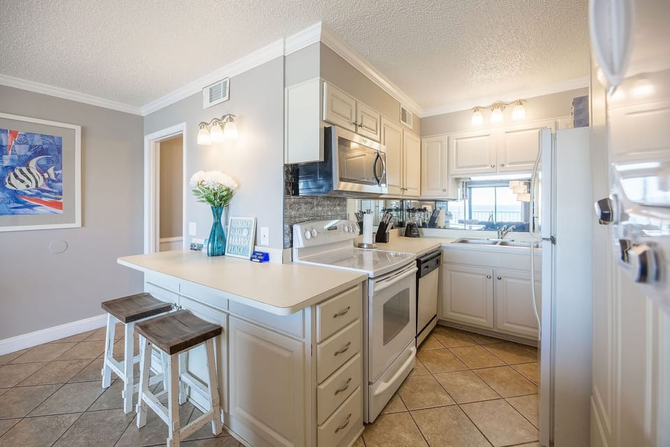 Fully-applianced kitchen and breakfast bar . Our counters are now granite.