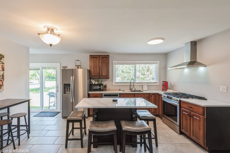 Kitchen with island seating for 4 people. There is also seating for 4 people along the side. 