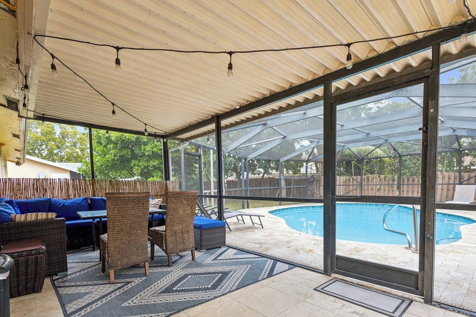 outdoor patio with view of pool, screen enclosed