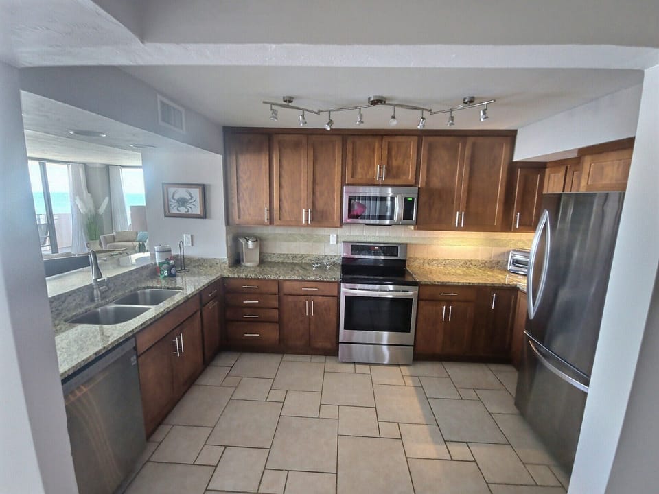 Fully stocked kitchen overlooks looking the living/dining areas