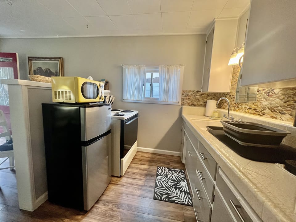 There's a full size stove and microwave and an apartment size refrigerator
