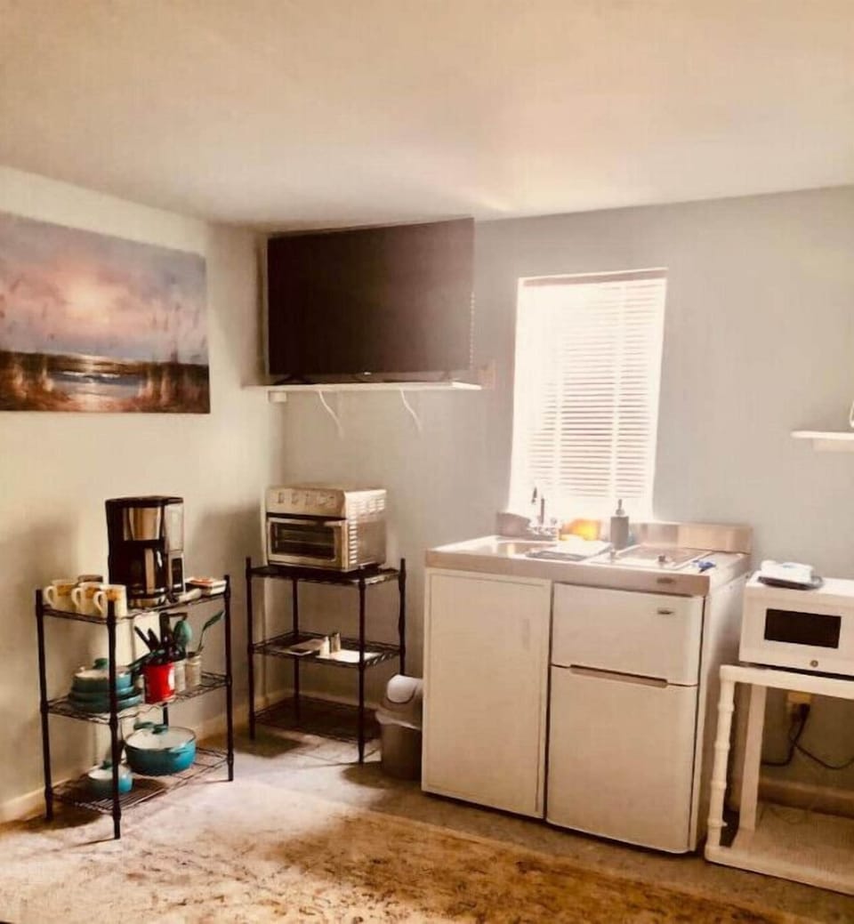 Mini kitchen, fridge, microwave, convection oven and coffee maker, pods, TV.