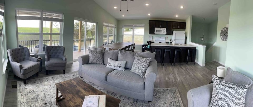 The great room, equipped with a smart TV, dining room seating for 10 (plus four bar stools at the counter), a fully stocked kitchen, and complimentary coffee bar.