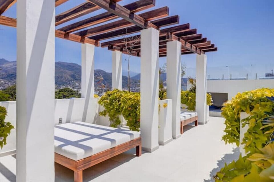 Daybeds on rooftop patio.
