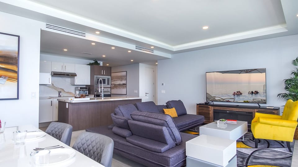 The main room brings together the kitchen, dining table, and seating space.