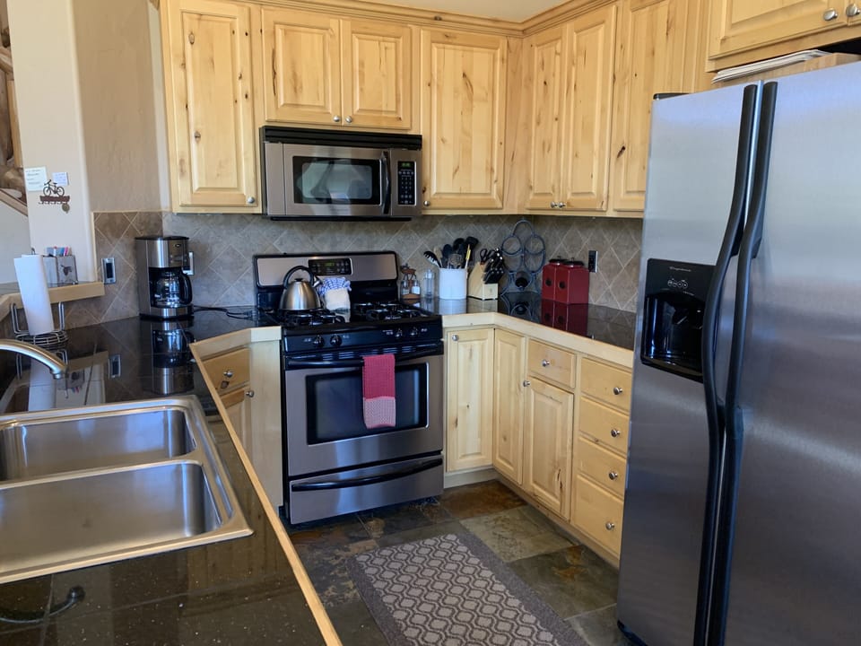 Well appointed kitchen with all the pans, pots, and utensils anyone needs. 