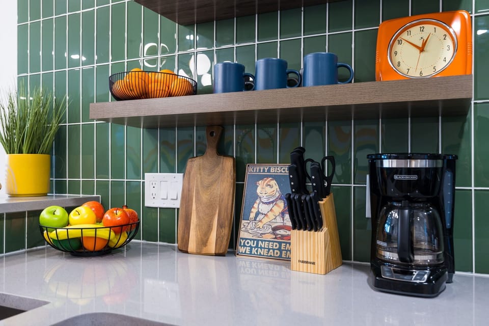 (1st Floor) Fully equipped kitchen with stainless steel appliances, basic cooking essentials, and kitchen island seating.