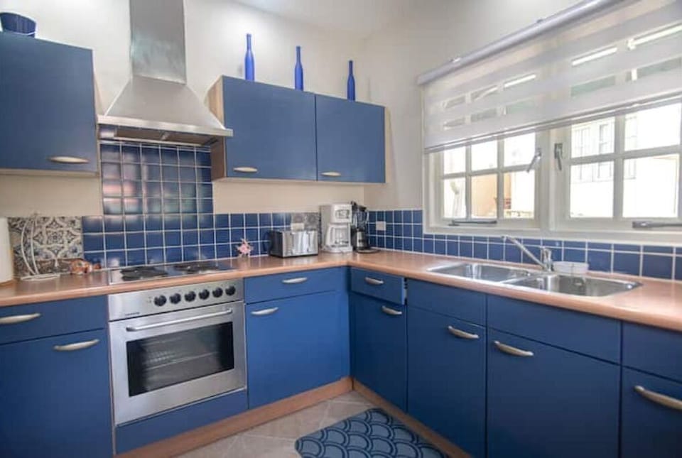 Kitchen eith fridge, freezer, oven,stove, coffee drip, microwave and toaster.