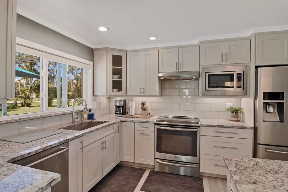 Stainless Appliances, Deep Single Bowl Sink, Granite Tops, View to Pool Area