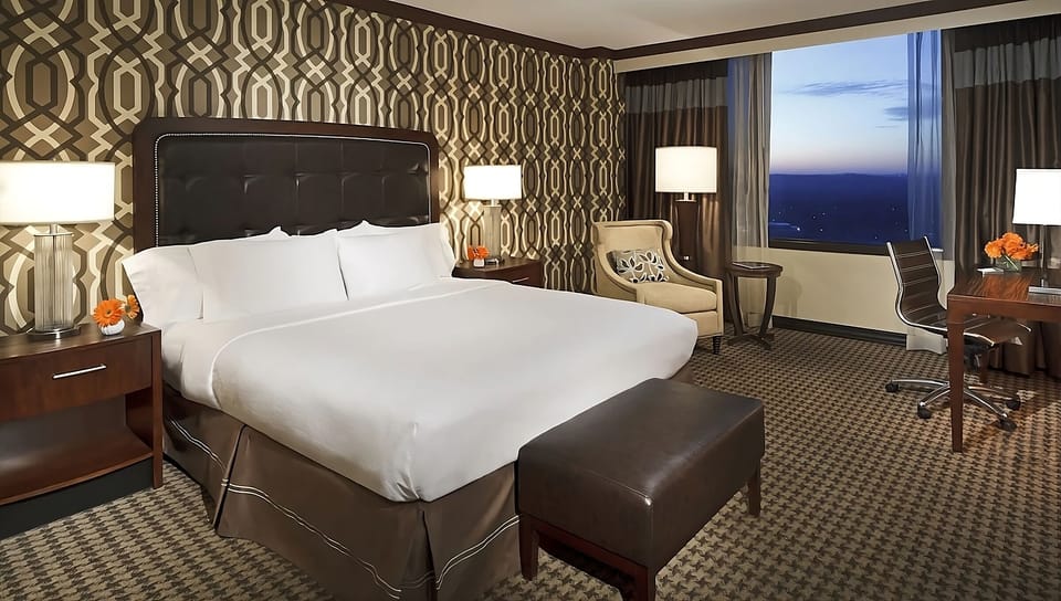 Unwind in a plush king bed with sparkling sunset views.