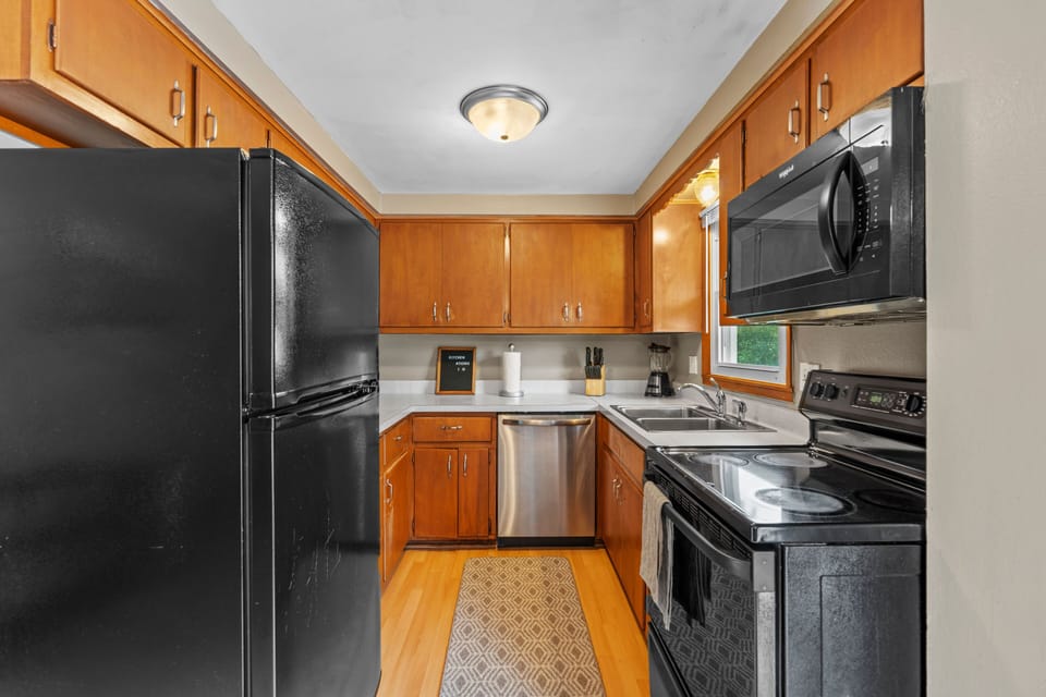 First floor kitchen with oven/range, full size refrigerator/freezer, dishwasher, and fully stocked with cookware, cutlery, glassware, etc. 