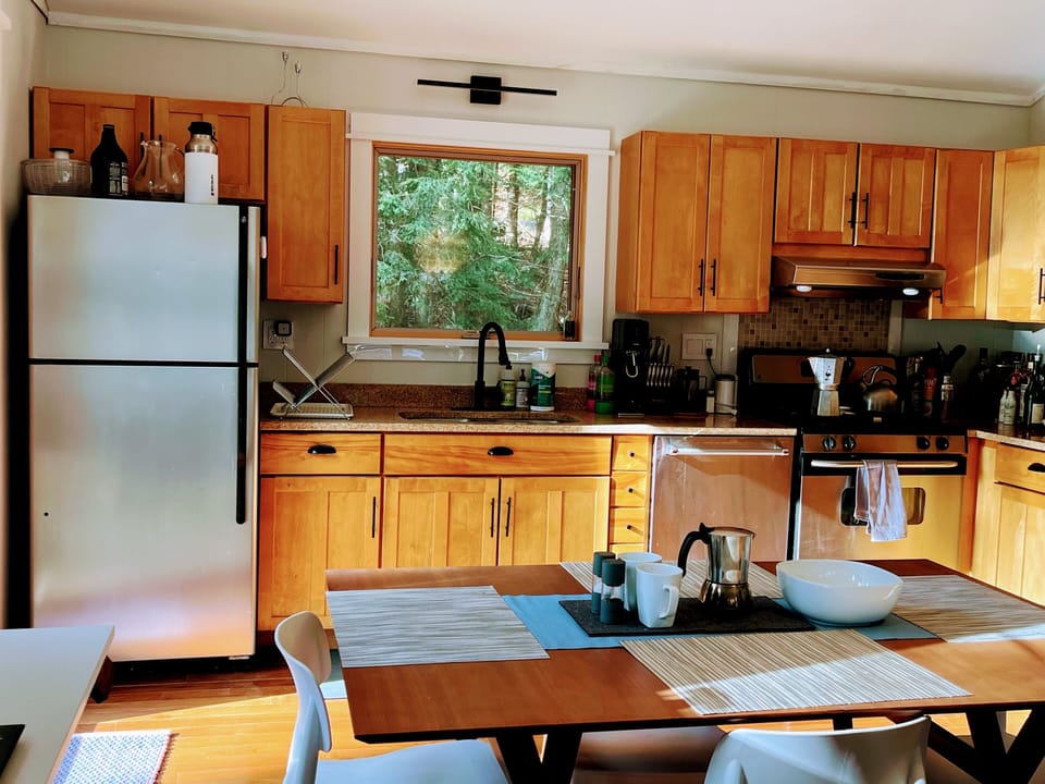 The kitchen is fully provisioned w All-Clad pots/pans, dishes & allkey utensils.