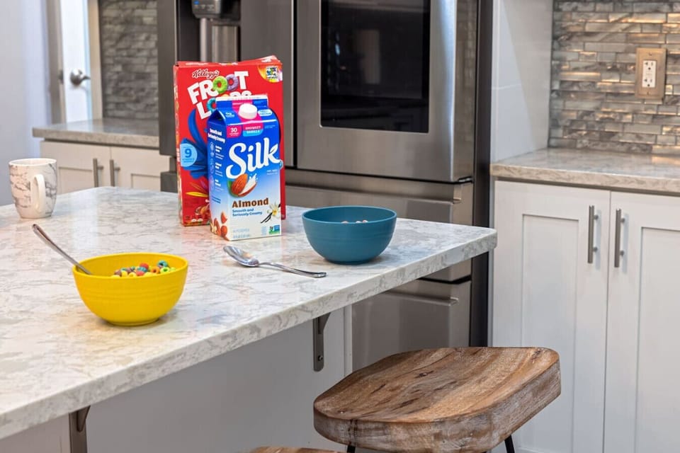 Bright Mornings, Simple Joys – Pour a bowl, sip your coffee, and ease into the day at this breezy kitchen island built for slow starts and sweet routines.