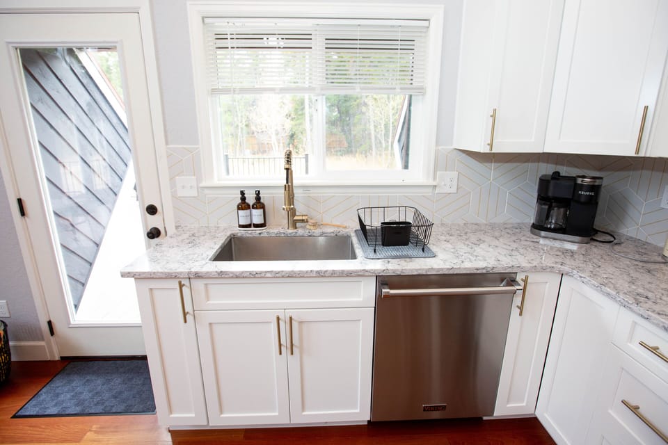 Large, stainless steel chef's sink, Viking dishwasher, Keurig coffee machine with pods and kettle