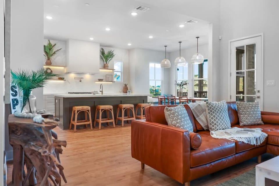 The main floor feels light and expansive with 20` ceilings, blending the living, dining, and kitchen into a seamless gathering space