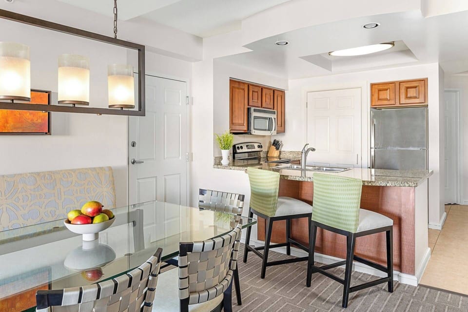Separate dining area with a large table and additional seats at the bar top.