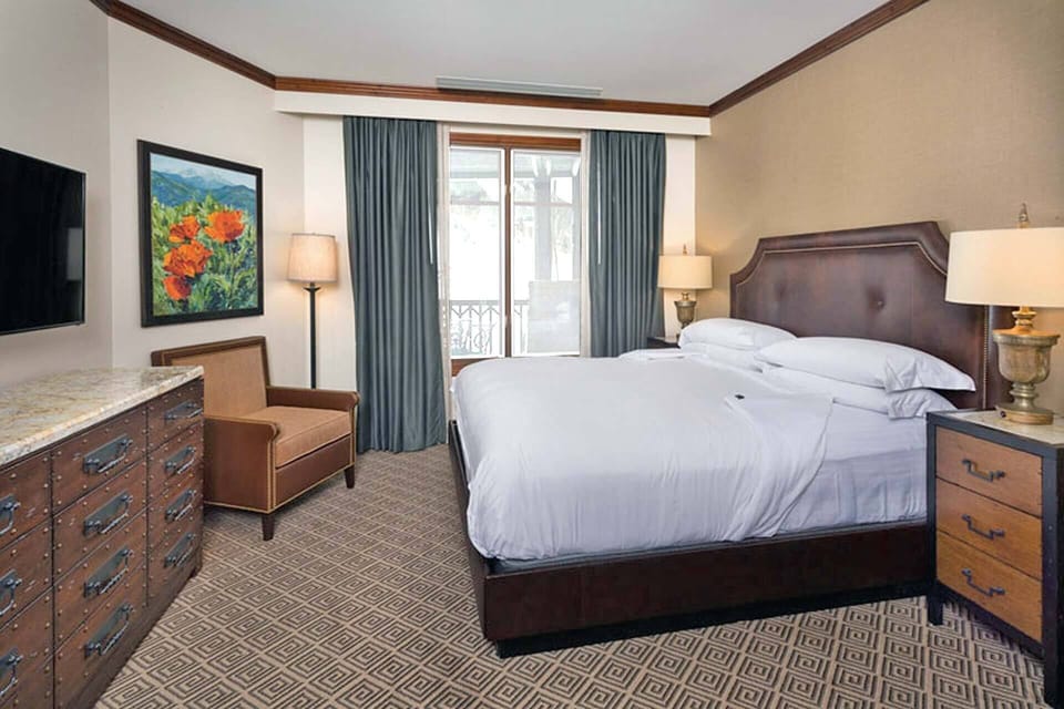 Primary Bedroom features a king bed, walk-in closet, and en suite bath.