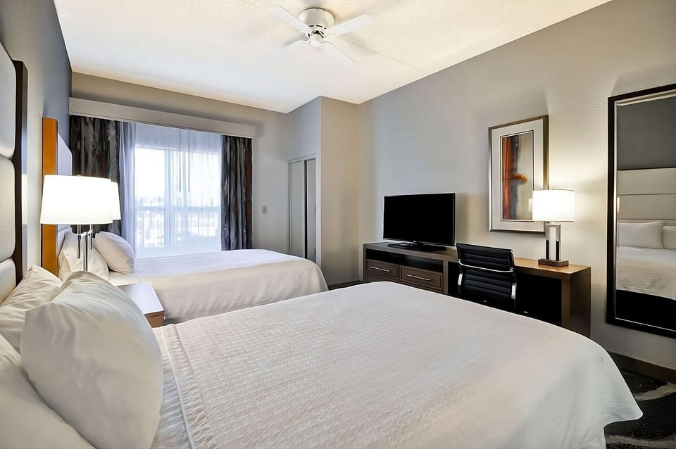 Recharge together in two plush beds with soft lighting.