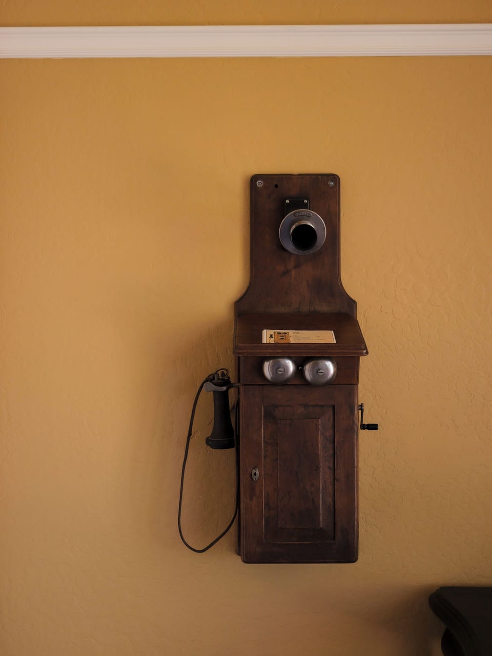 A charming vintage wall phone, adding a nostalgic touch to the space.