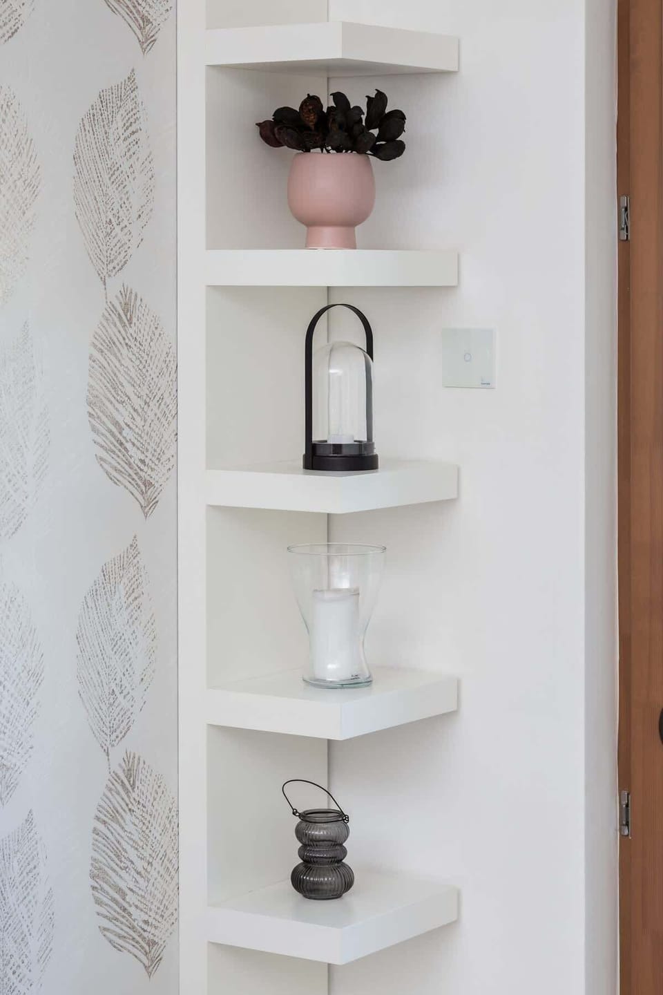 A close-up of decorative shelves with neatly arranged decor items, adding charm to the space.
